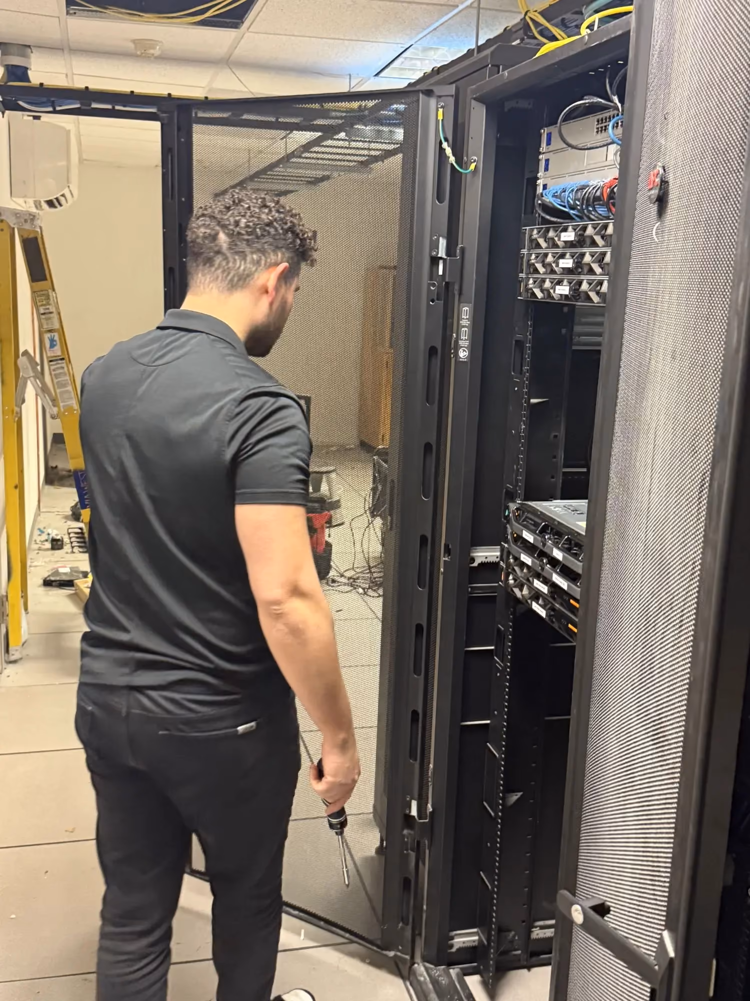 MBPS technician working at an open server rack
