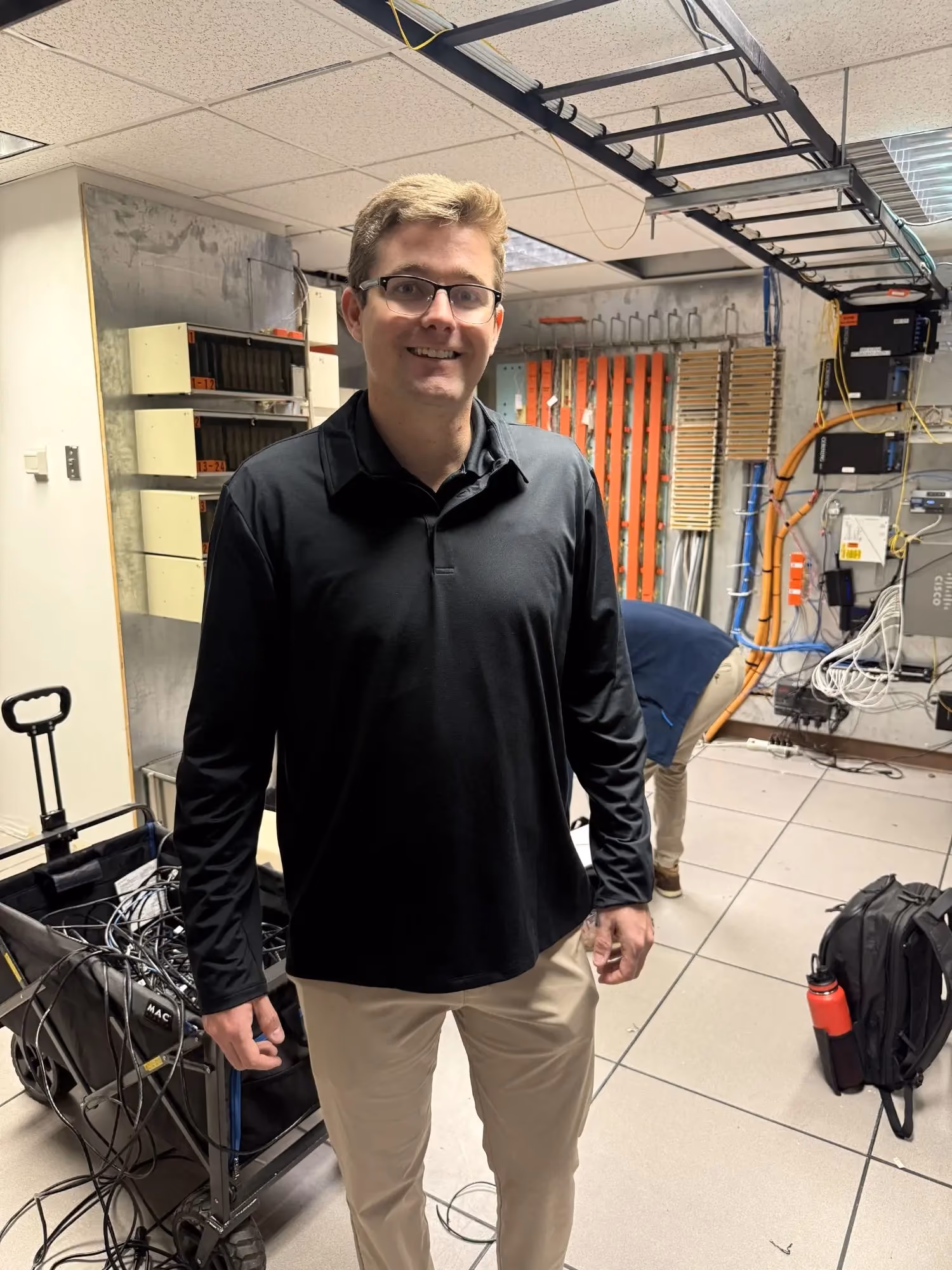 MBPS engineer standing in an equipment room