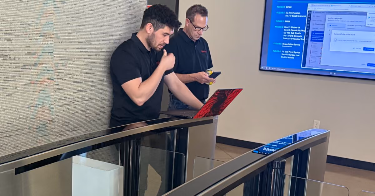 Two MBPS staff members by the office entry turnstiles