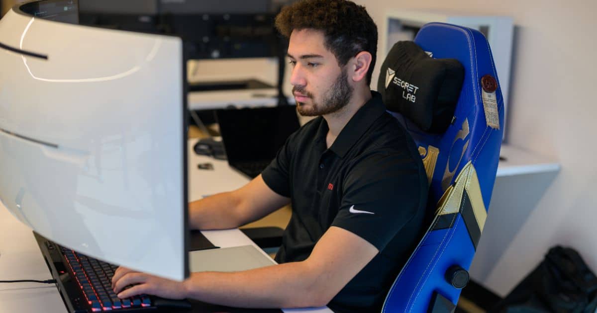 MBPS technician managing unified communications systems at a curved monitor