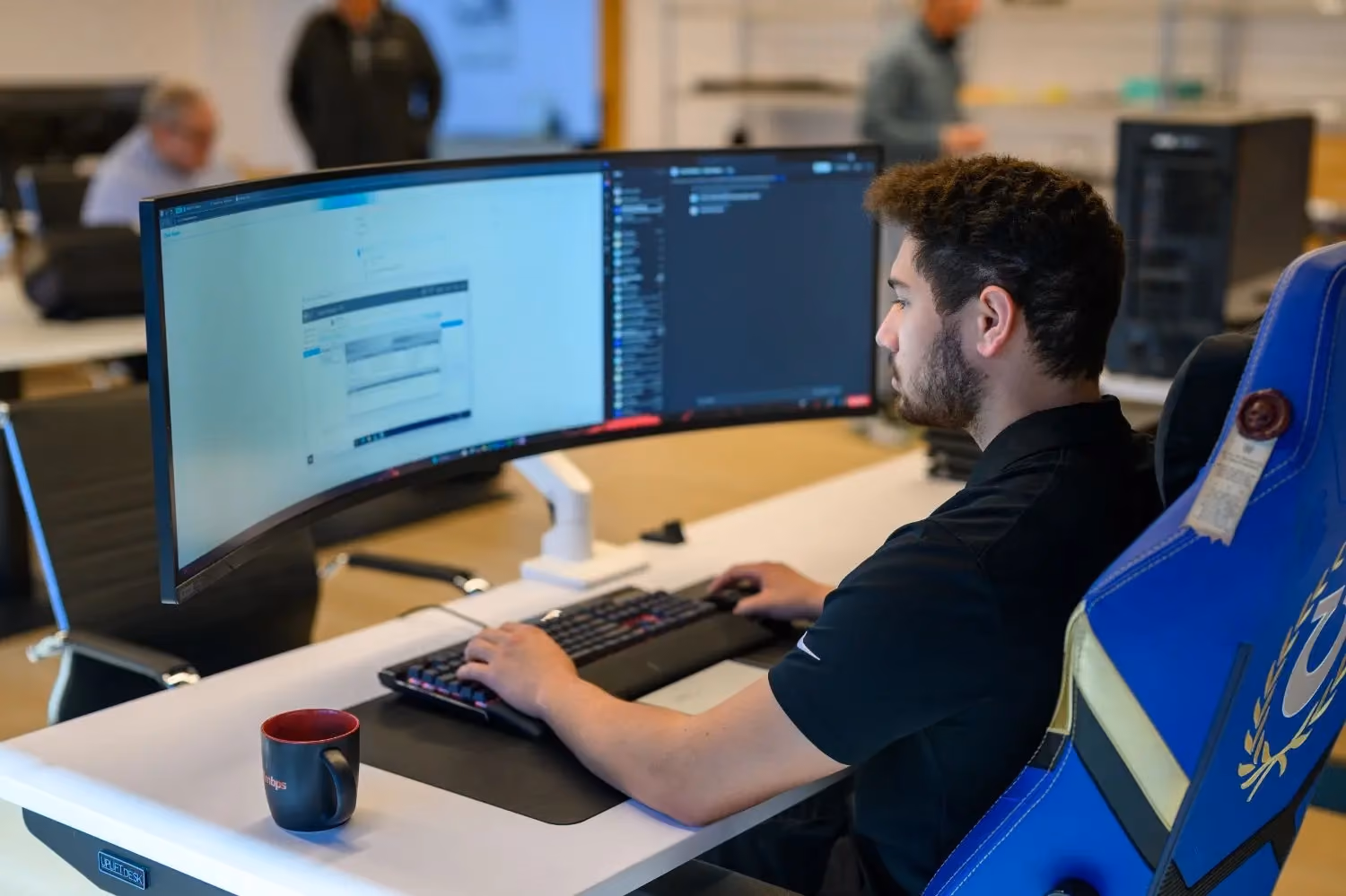 MBPS technician working at a curved ultrawide monitor