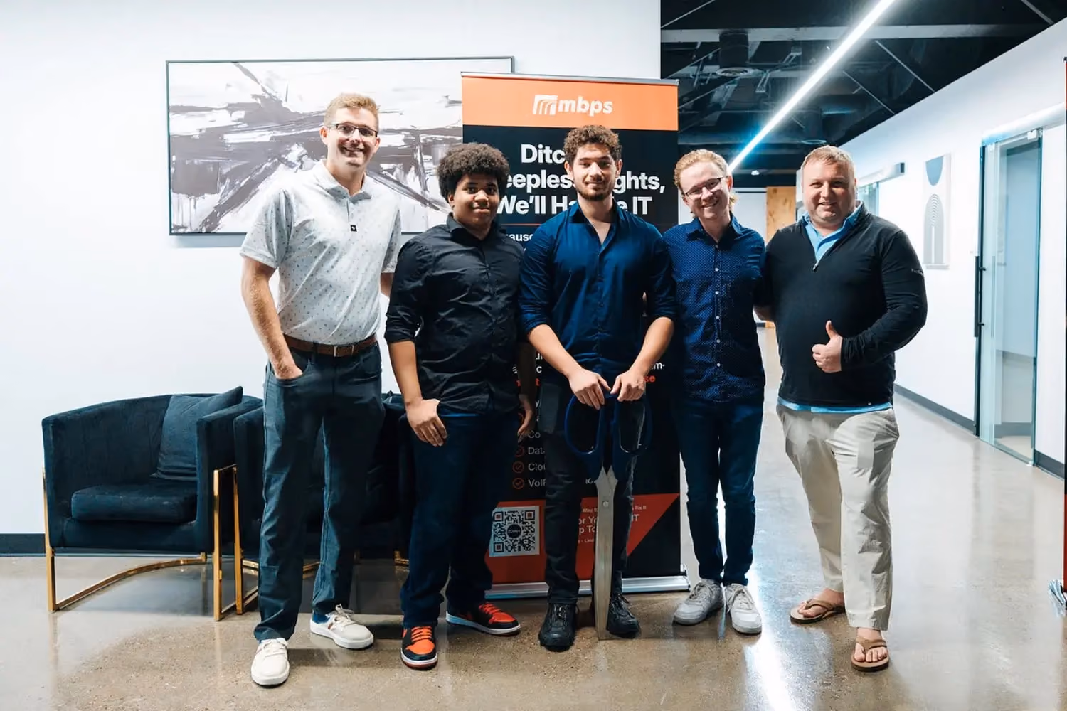 MBPS team standing together in front of a marketing display
