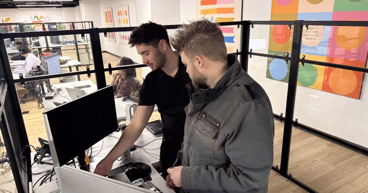 MBPS engineers reviewing a screen together in the open office