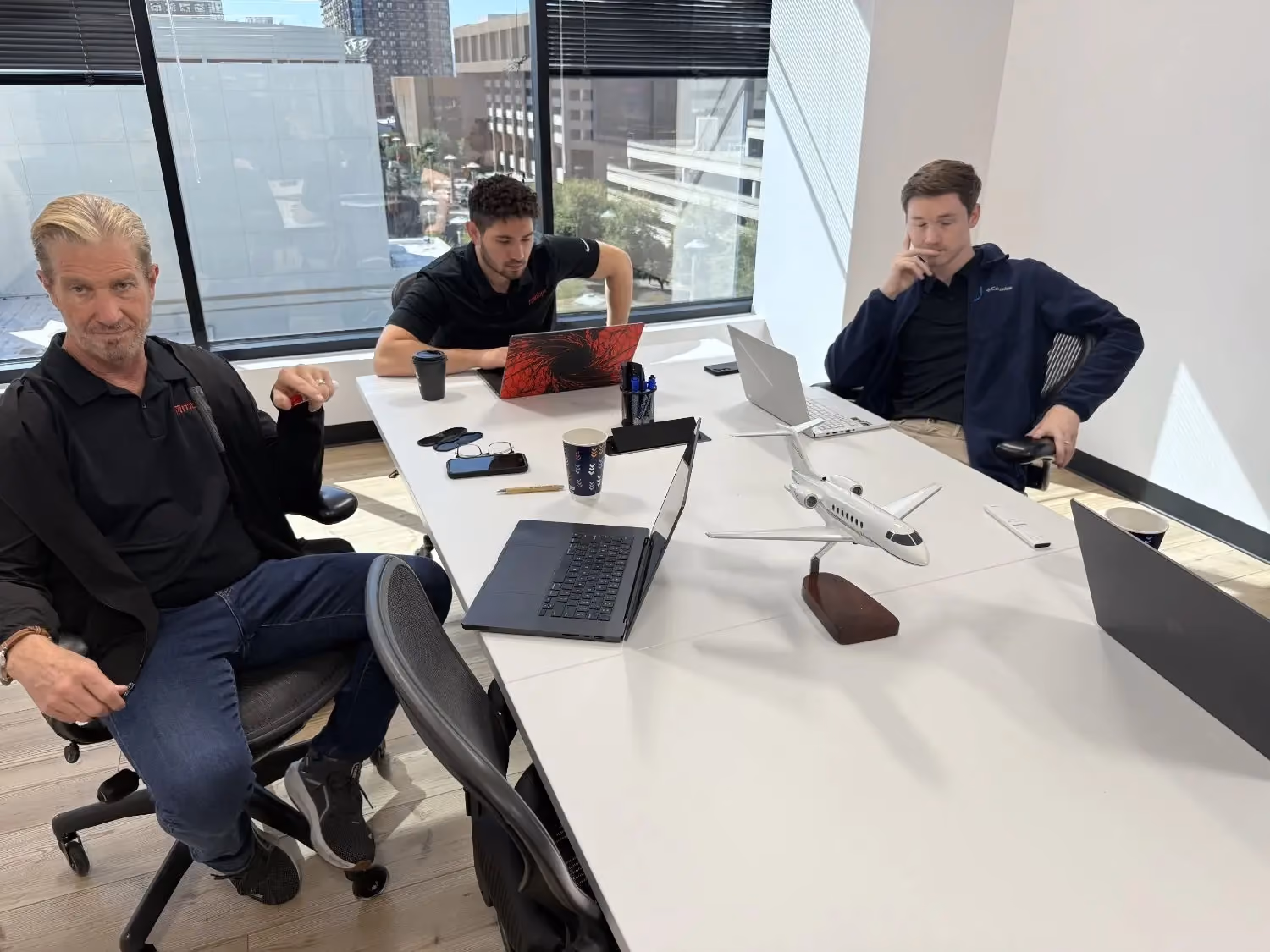 MBPS colleagues meeting around a conference table with a city view