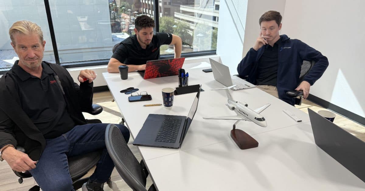MBPS team meeting around a conference table with laptops