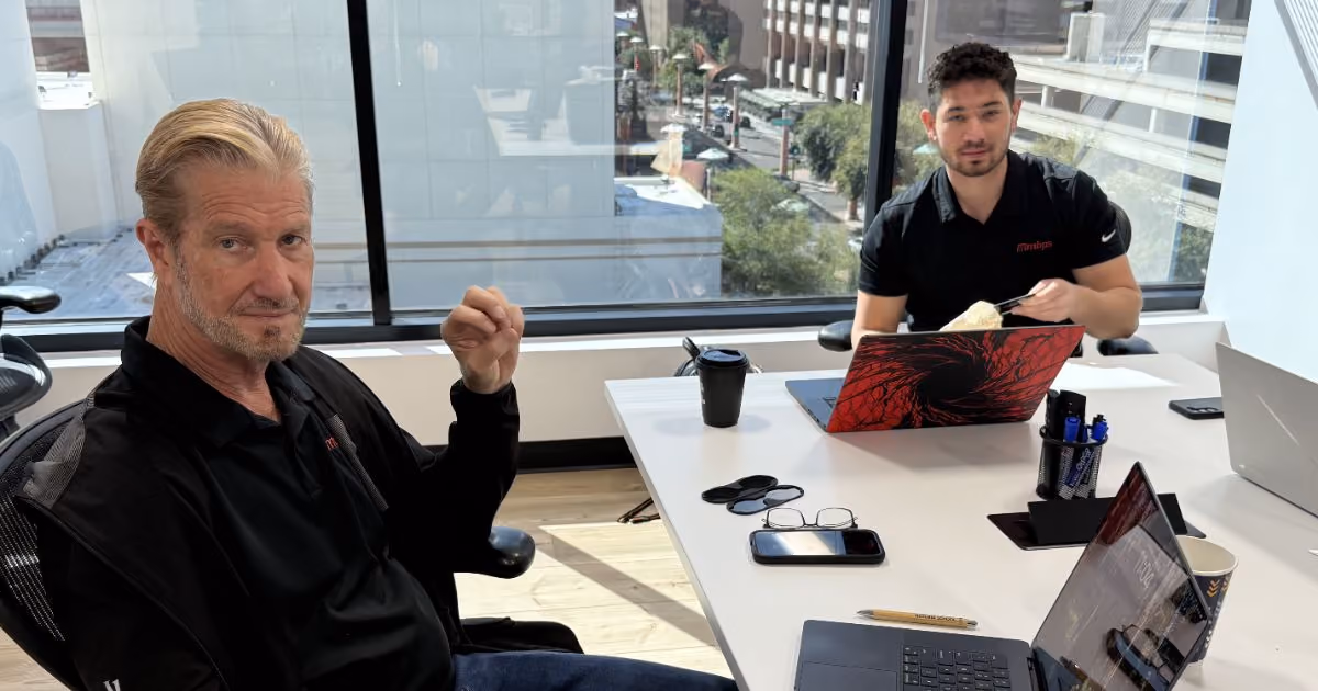 Two MBPS colleagues talking across a conference table