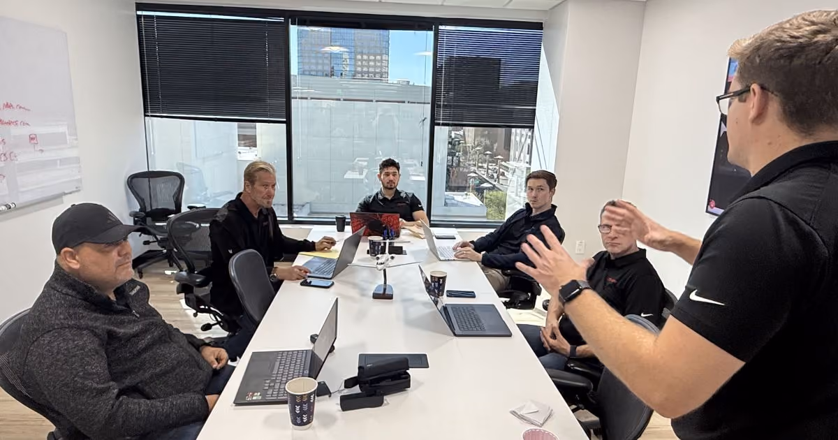 MBPS team collaborating with a client around a conference table