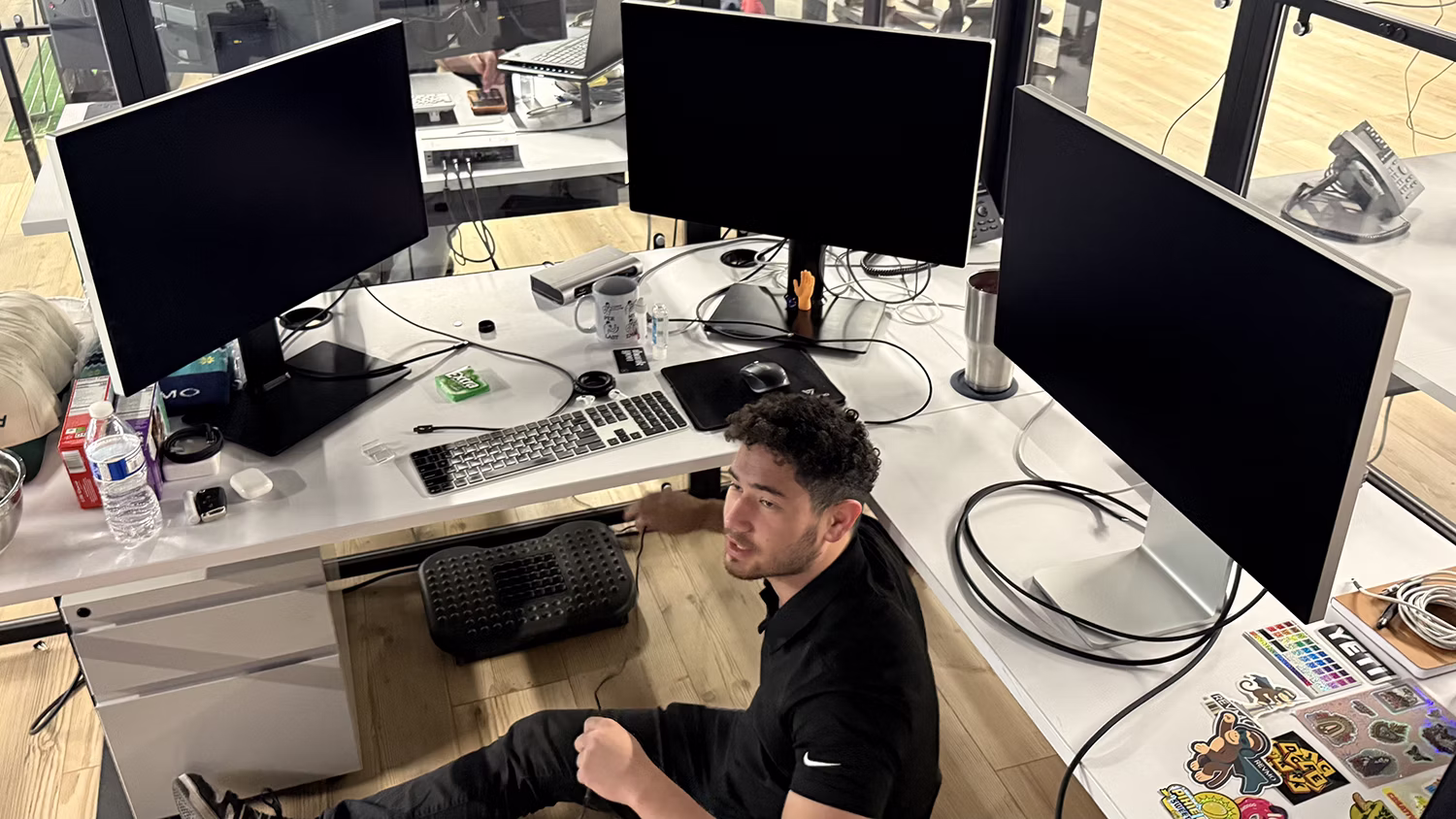 MBPS engineer at a workstation surrounded by monitors