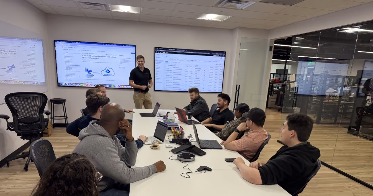 MBPS staff meeting facing wall-mounted presentation screens