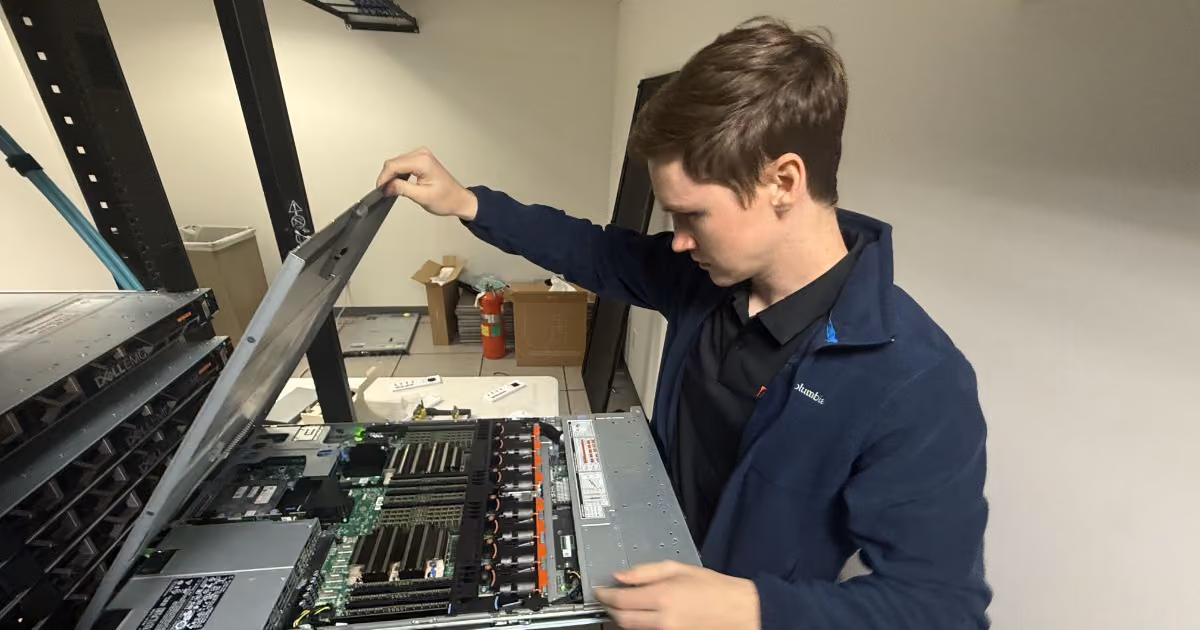 MBPS engineer inspecting the inside of a rack-mounted server