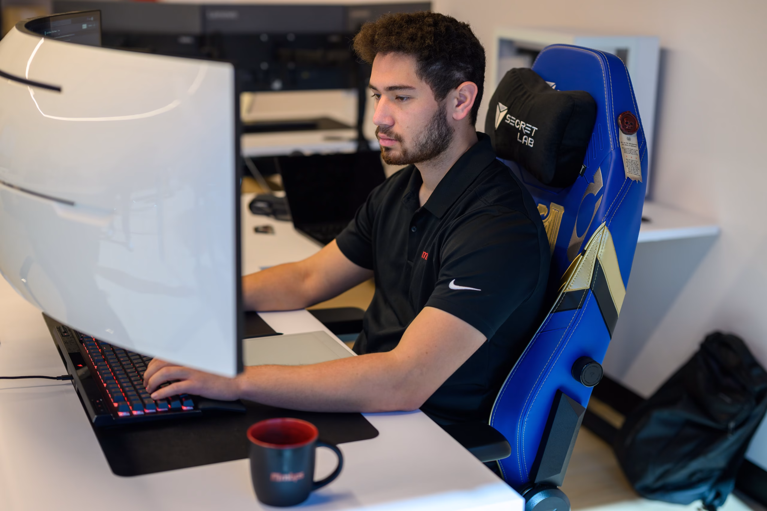 MBPS engineer working at a dual-monitor desk