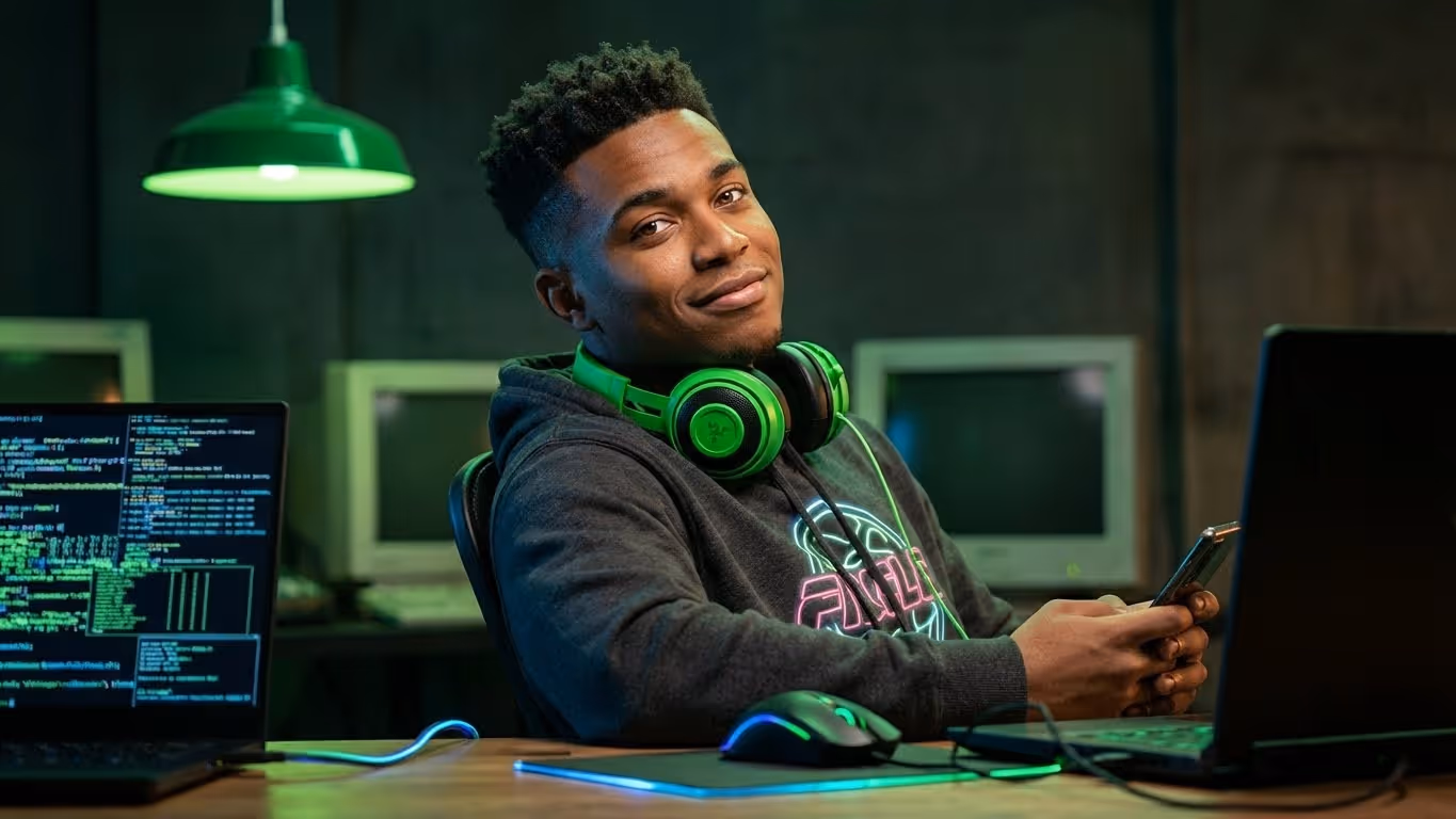 The Kid, a character from the MBPS malware family campaign, wearing headphones at a laptop